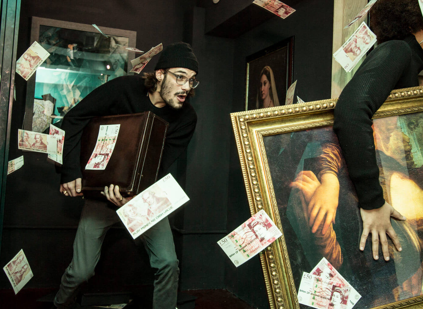 Two thieves stealing cases of money and paintings