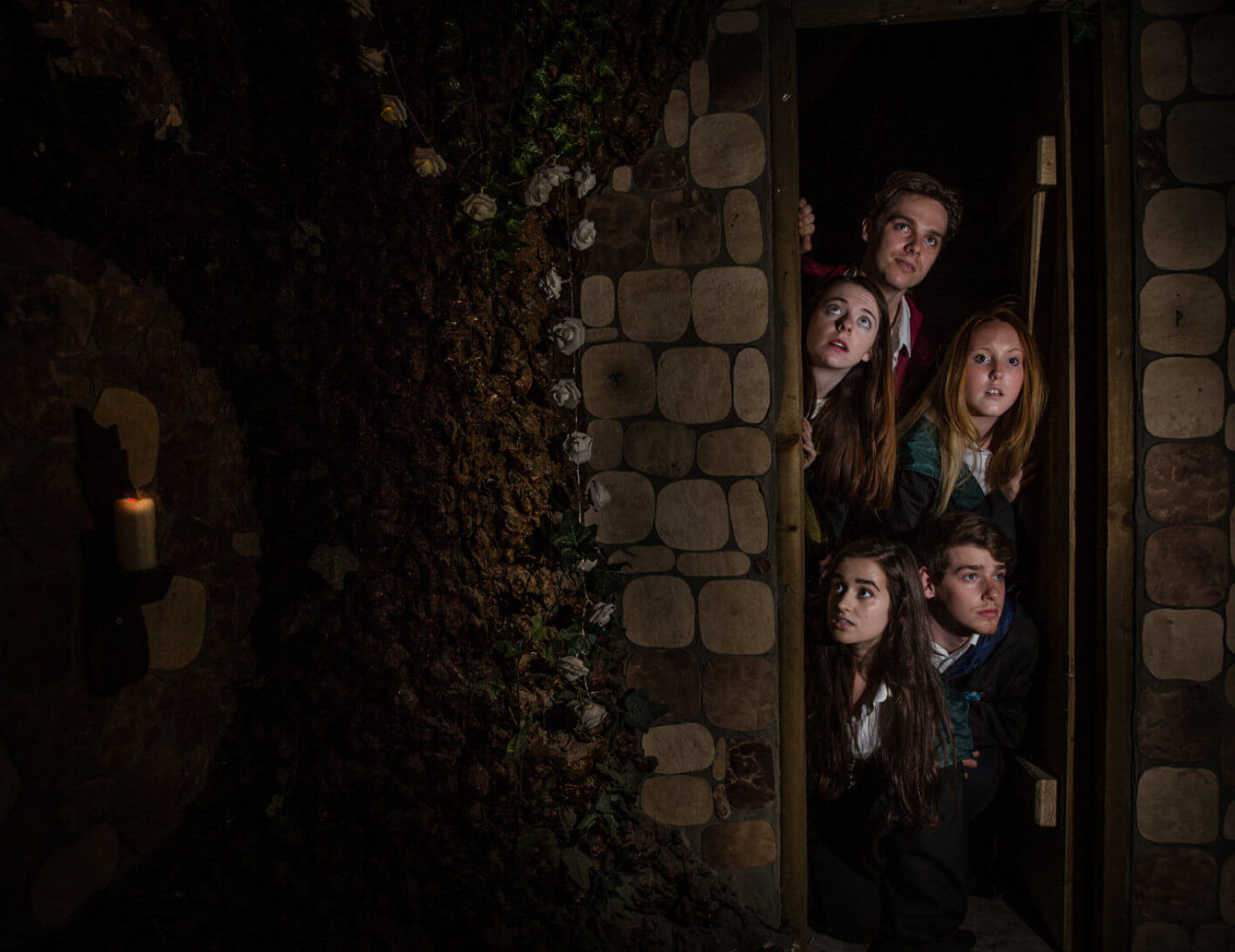 5 witches and wizards standing in a doorway
