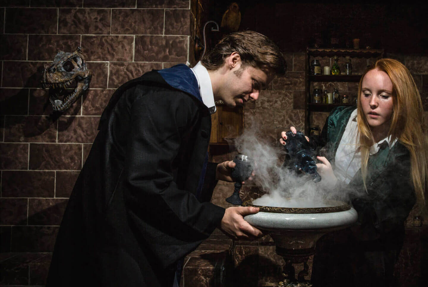 Witch and wizard standing over a smoking cauldron
