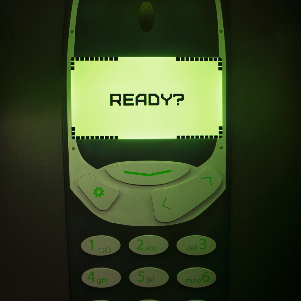 Large Y2K brick phone reading 