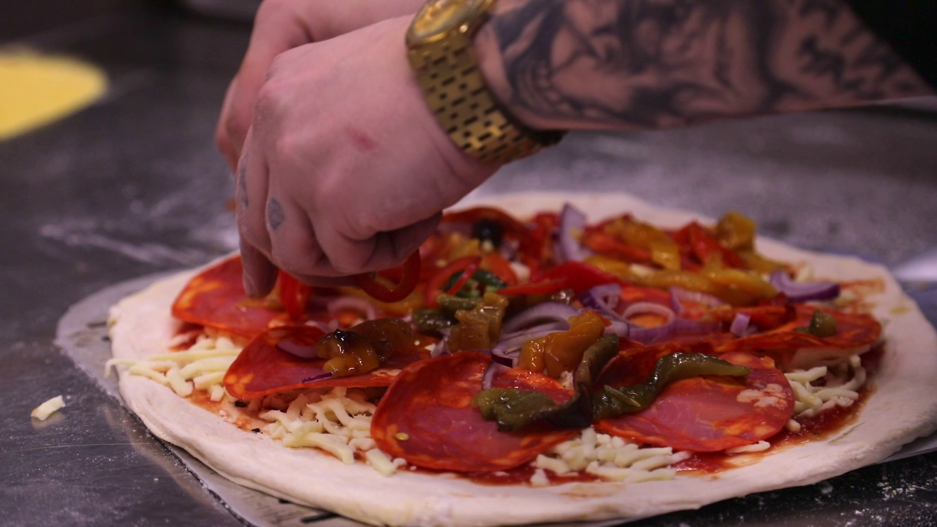 Ingredients being added to pizza